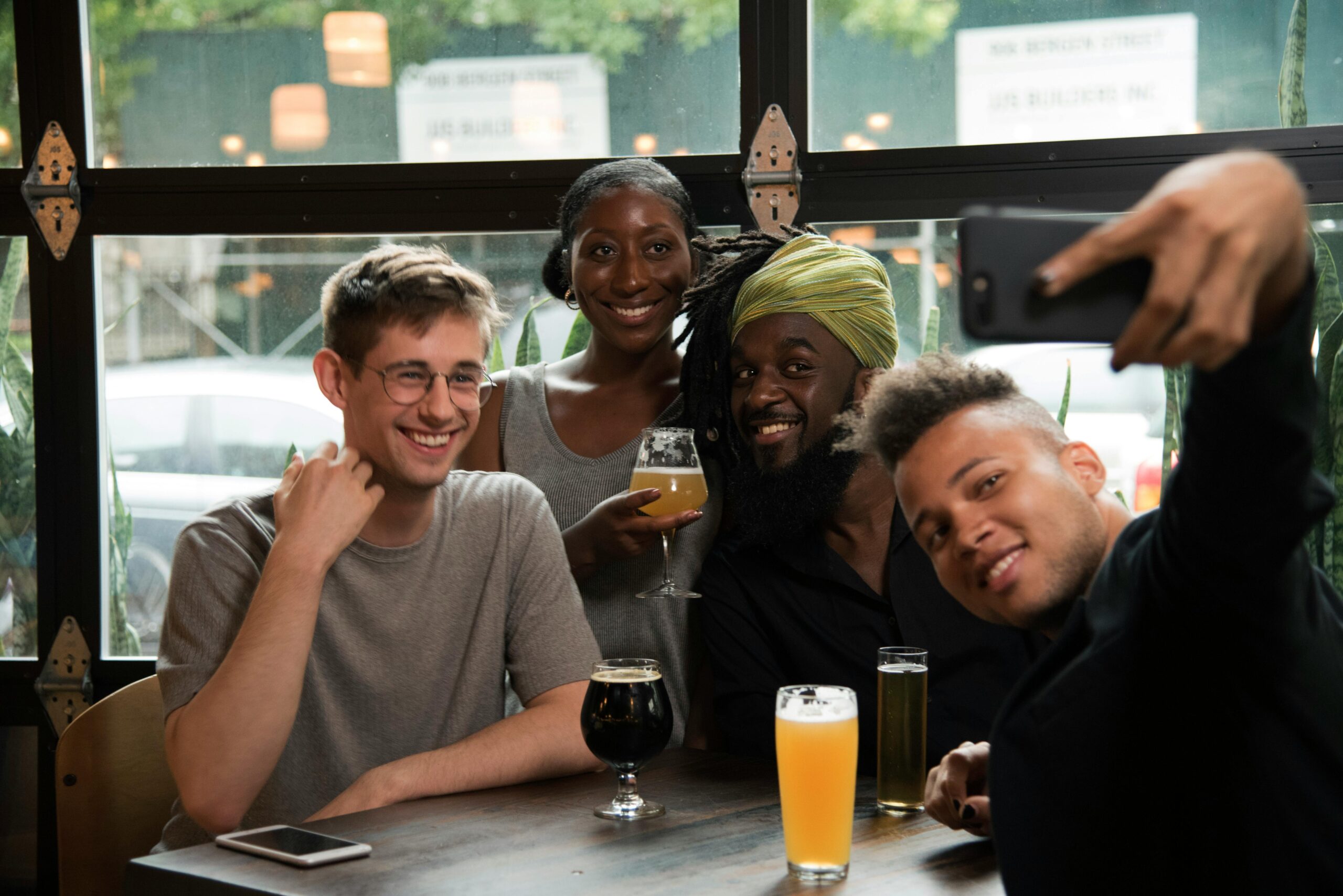 friends taking selfie and drinking