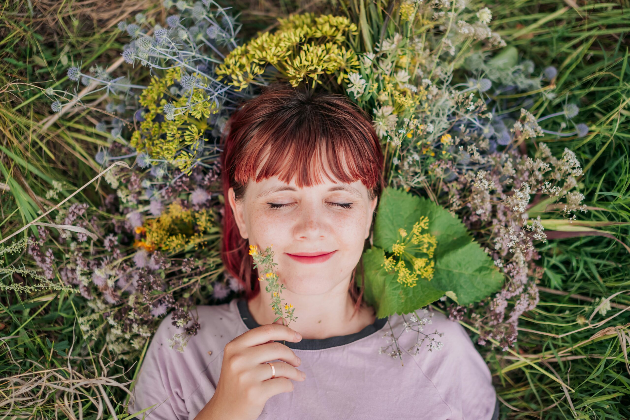 woman laying on ground smiling