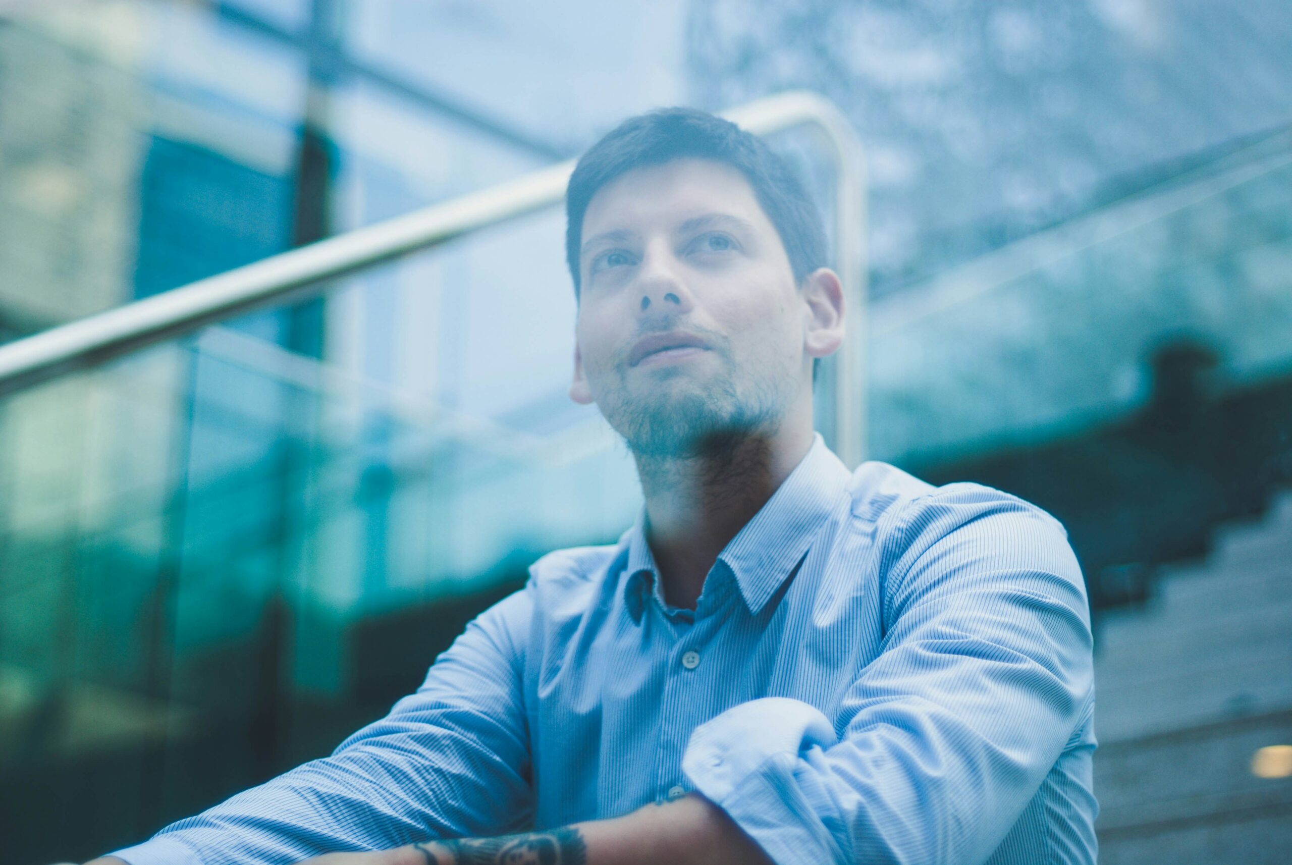 man sitting outside thinking