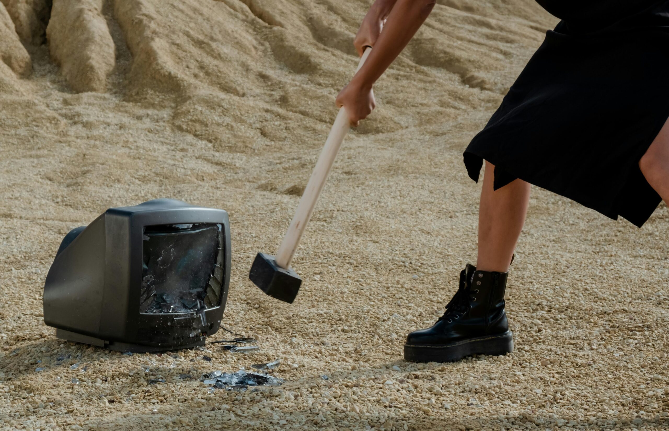 person hitting tv with hammer