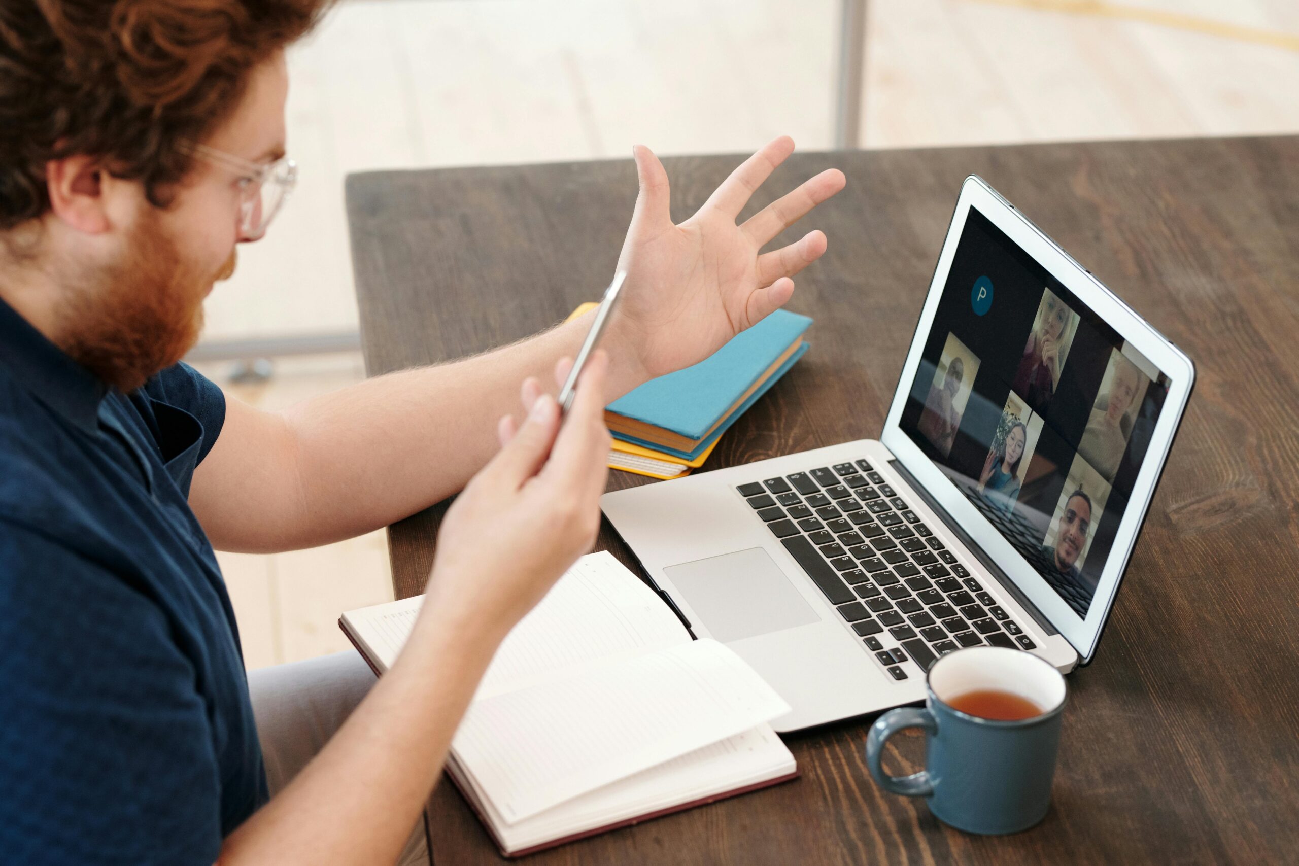 man on a laptop with other people