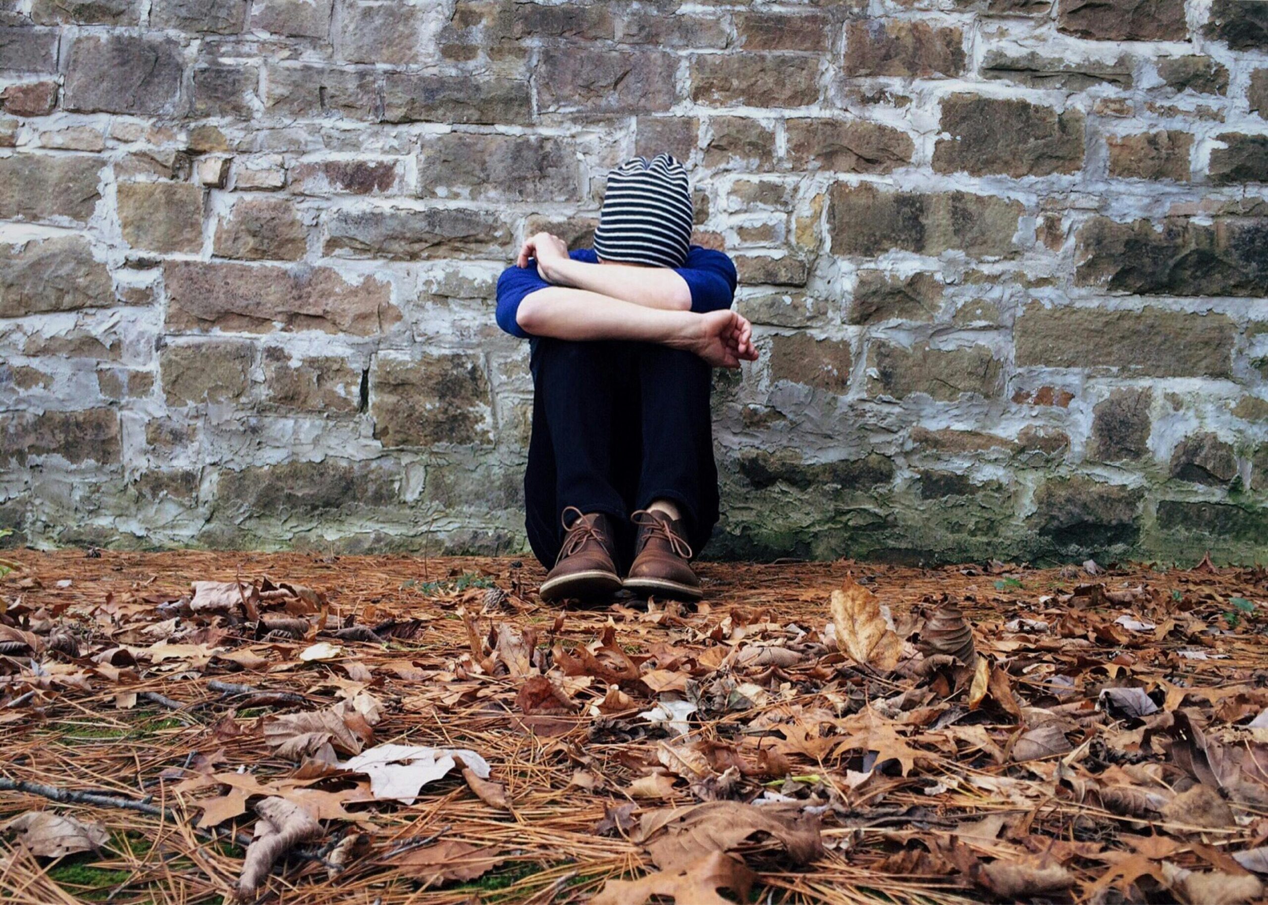 man sitting down all sad