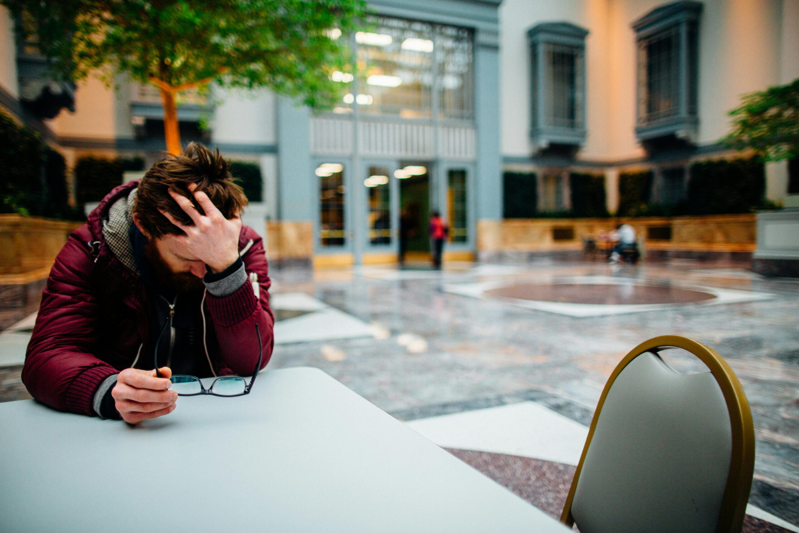 man depressed at a table