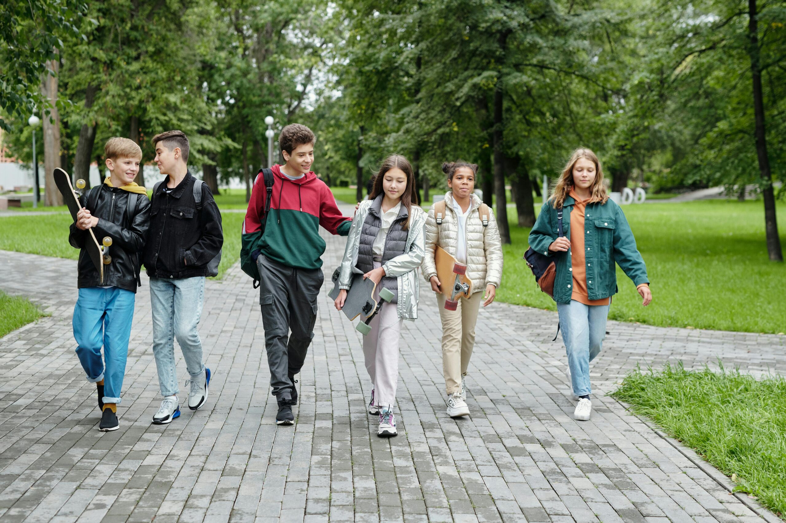 teenagers walking in a park together
