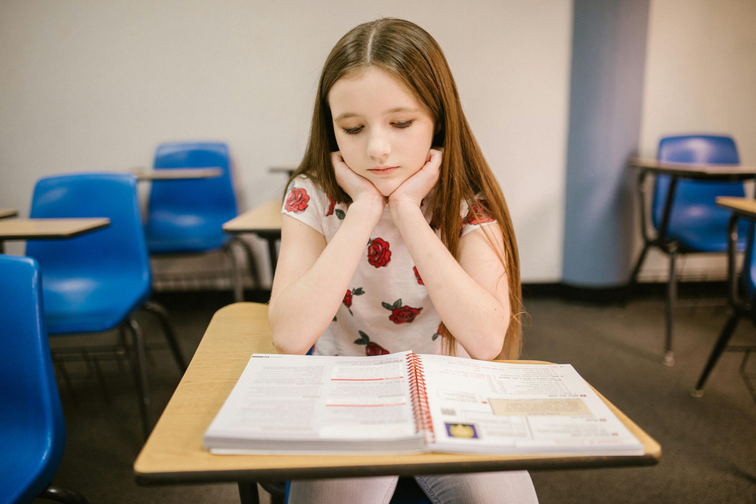little girl reading and suffering from depression