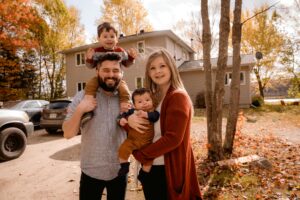 family in front of a house