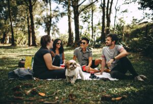 group friends outside with a dog