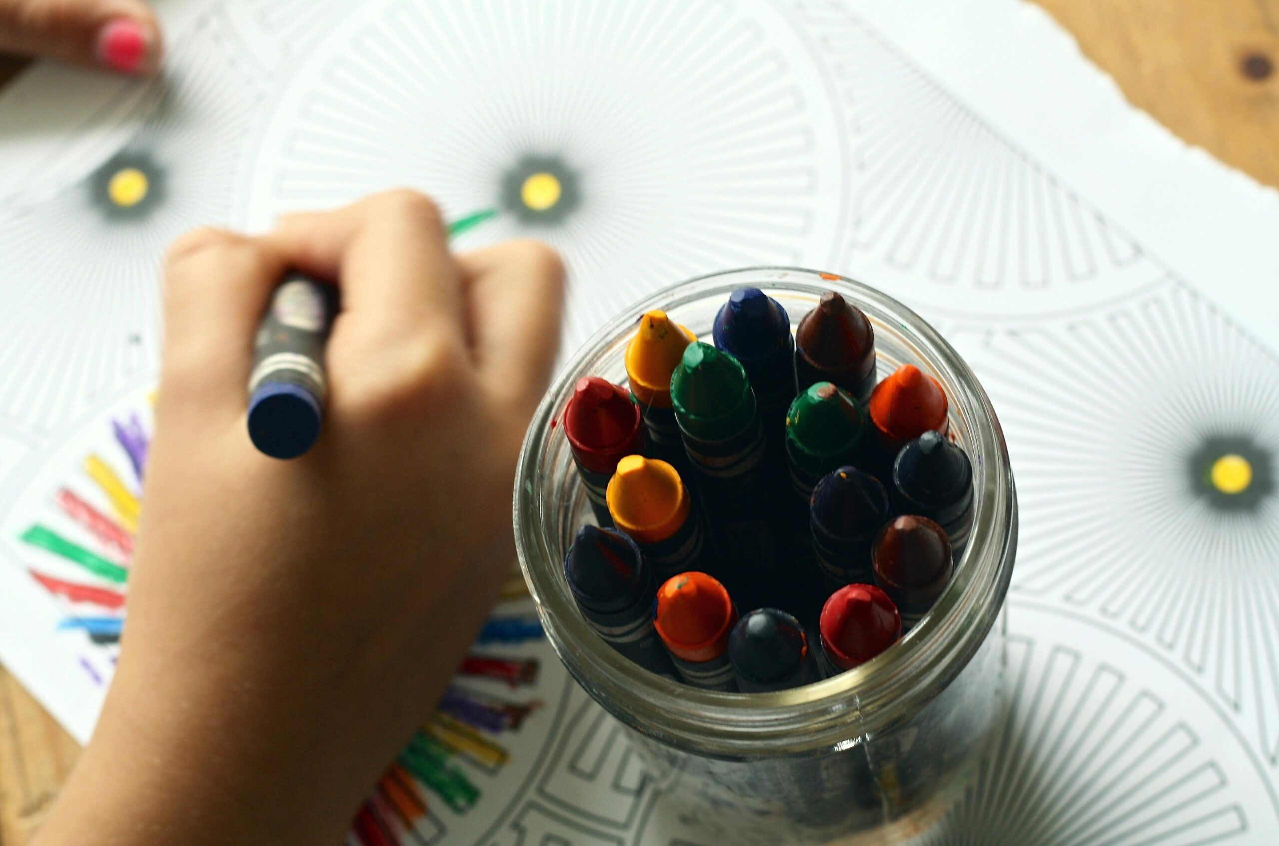 young kid drawing with crayons