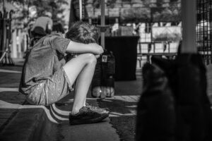 young man sitting on curb