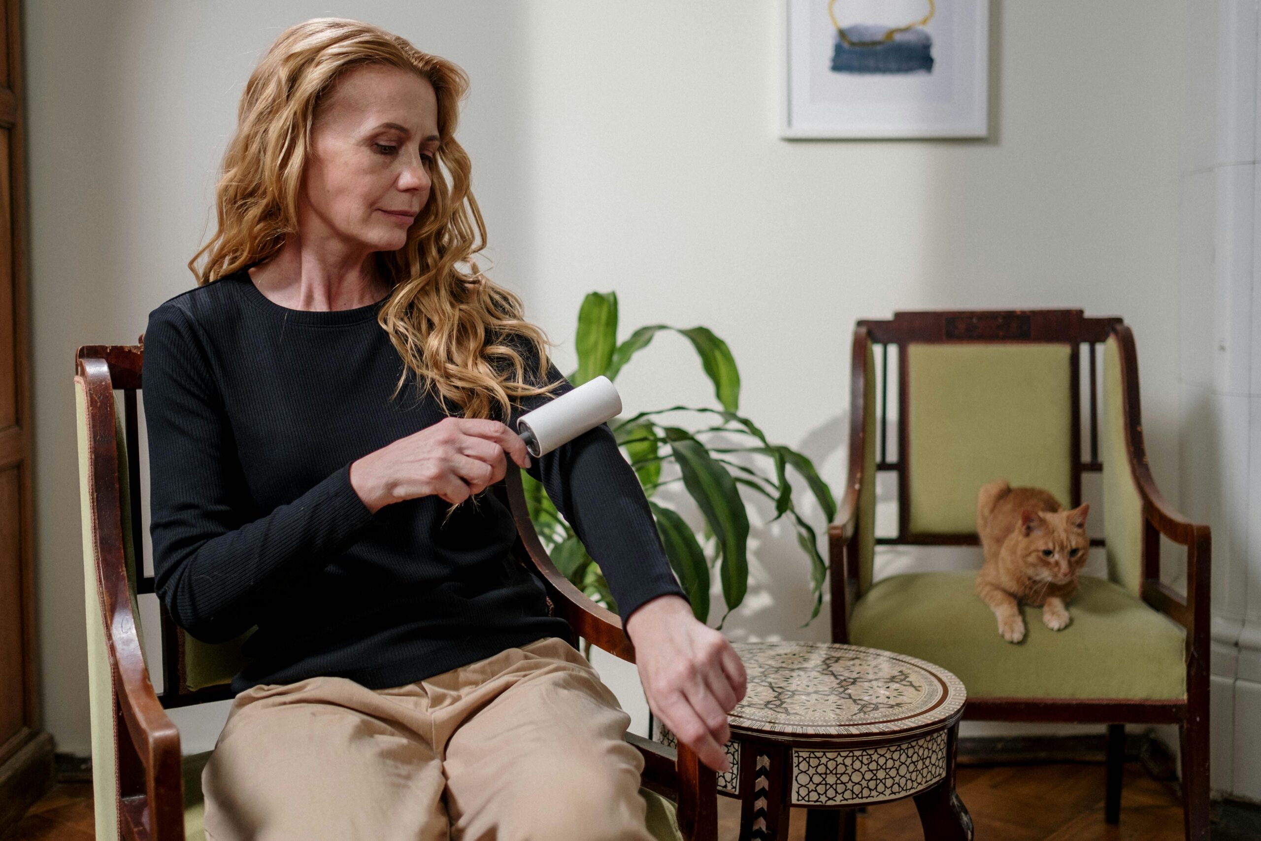 woman using lint roller on her arm