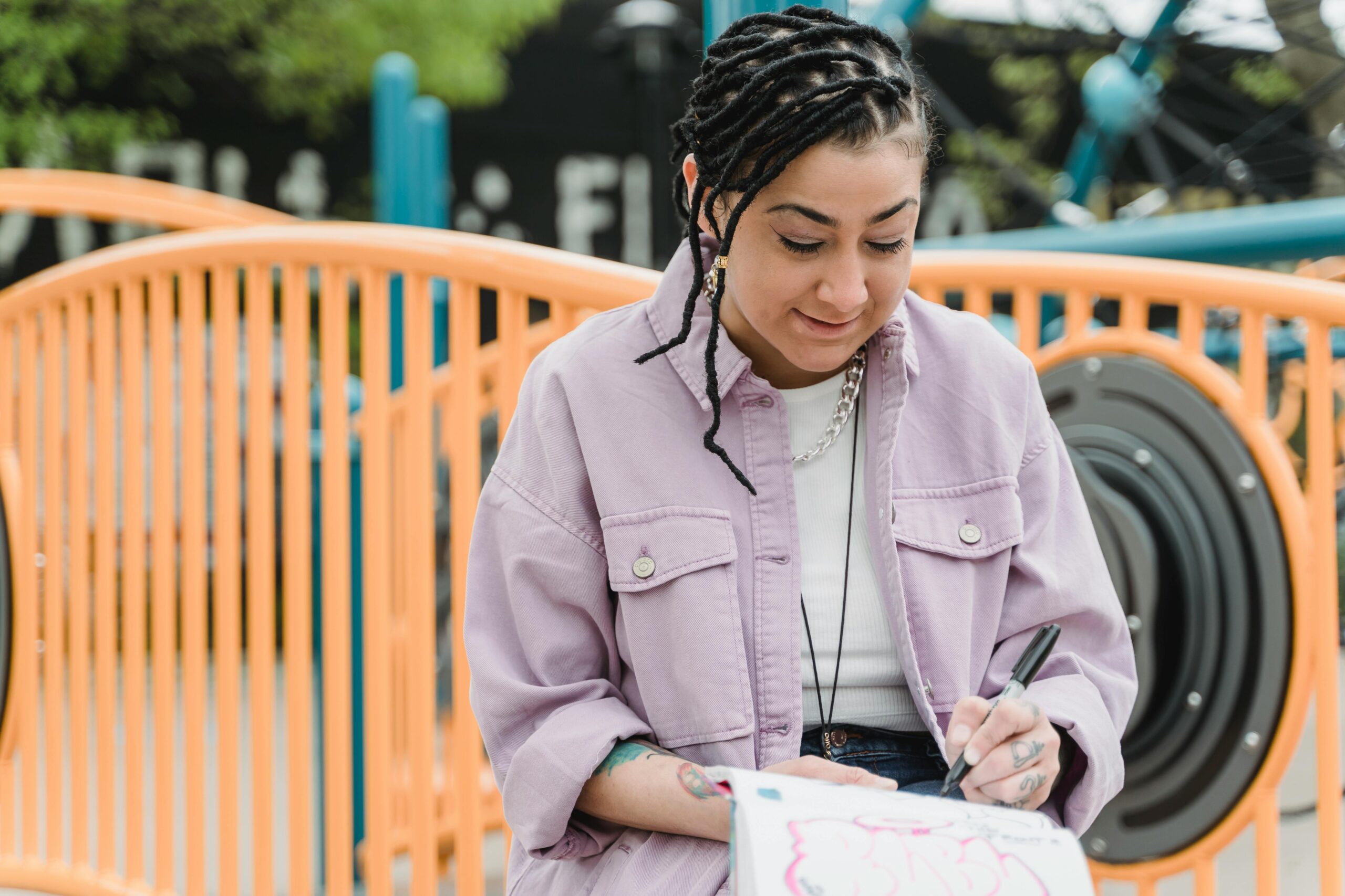 young woman reading a book at the park